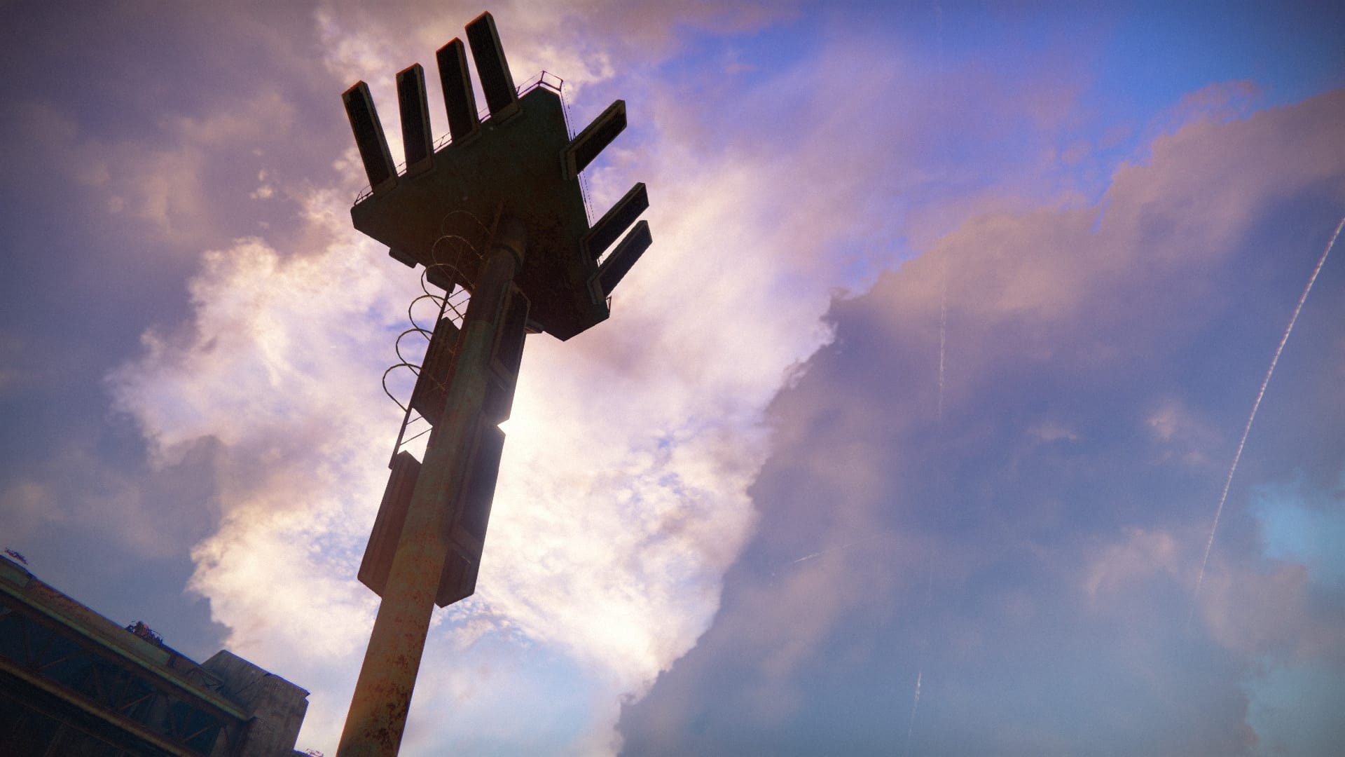 a transmission tower with clouds behind